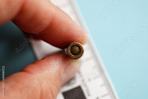 Close up shot focus selective on an old unexploded bullet held by a hand, for police ballistics studies
