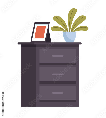 wooden drawer with houseplant and portrait icon