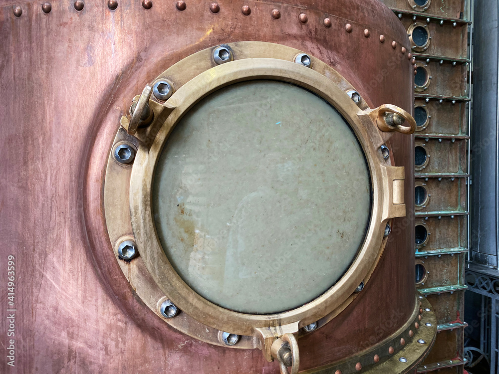 Close up of a copper alcohol distillery brewing still