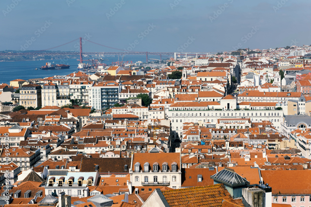 A panoramic view over Lisbon with beautiful reed roofs and river Tejo in summer sunlight.