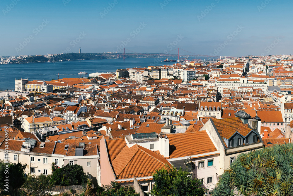 A panoramic view over Lisbon with beautiful reed roofs and river Tejo in summer sunlight.