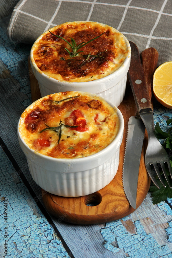 Cod casserole with cheese, sour cream and tomatoes. White fish casserole with cheese and sour cream, Baked fish on pot. Julienne of seafood Cod casserole with cheese, sour cream and tomatoes. White fish casserole with cheese and sour cream, Baked fish on pot. Julienne of seafood