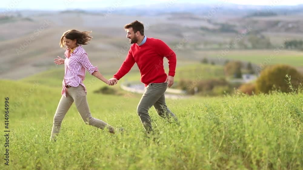 couple running carefree on meadow enjoying freedom and fresh air couple running carefree on meadow enjoying freedom and fresh air