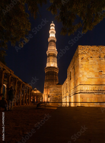 Qutub Minar a highest minaret in India standing 73 m tall tapering tower of five storeys made of red sandstone. It is UNESCO world heritage site at New Delhi, India photo