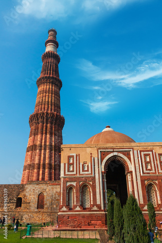 Qutub Minar a highest minaret in India standing 73 m tall tapering tower of five storeys made of red sandstone. It is UNESCO world heritage site at New Delhi, India photo
