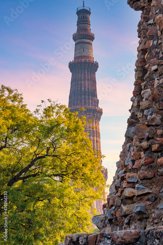 Qutub Minar a highest minaret in India standing 73 m tall tapering tower of five storeys made of red sandstone. It is UNESCO world heritage site at New Delhi, India photo