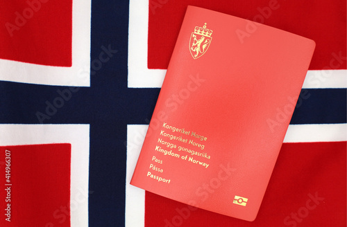 Drammen, Norway - January 2 2021 - Norwegian passport on Norway flag. photo