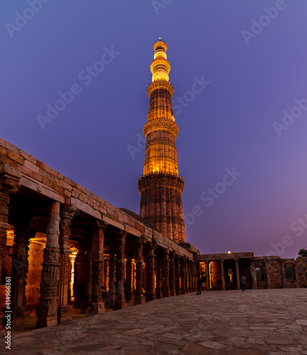 Qutub Minar a highest minaret in India standing 73 m tall tapering tower of five storeys made of red sandstone. It is UNESCO world heritage site at New Delhi, India photo
