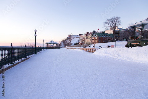 West view of famous Dufferin Terrace in the old town seen with a fresh coat of snow during a blue hour winter morning, Quebec City, Quebec, Canada