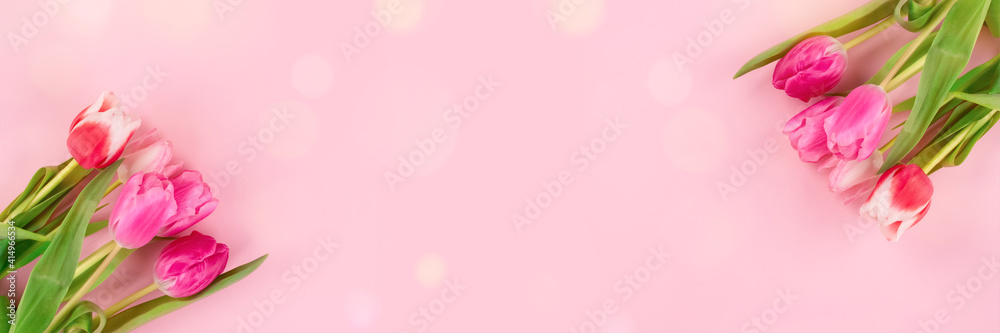 Banner with beautiful colorful tulips on light pink background with copy space and bokeh lights. Design for greeting card - Mother's Day, Women Day, 8 March or Valentines Day concept, selective focus Banner with beautiful colorful tulips on light pink background with copy space and bokeh lights. Design for greeting card - Mother's Day, Women Day, 8 March or Valentines Day concept, selective focus