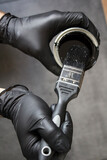 Man holding black paint and brush. Home renovation concept. Close up photo of working man. 