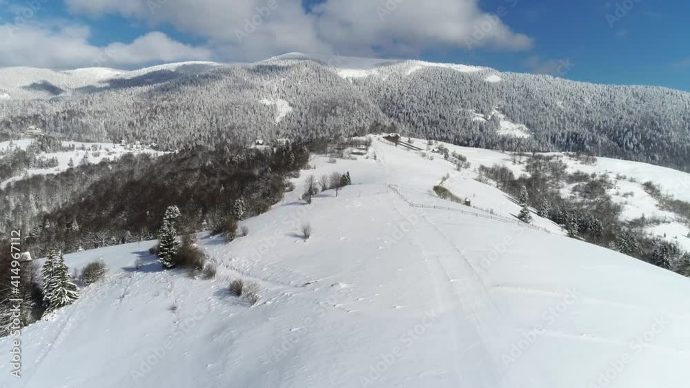 Winter landscape, beautiful snowy mountains. Snow-covered hills and mountains at sunny day. Frost weather. Aerial footage of Carpathian Mountains. Adventure Hiking Trekking Ski Vacation Travel Concept Winter landscape, beautiful snowy mountains. Snow-covered hills and mountains at sunny day. Frost weather. Aerial footage of Carpathian Mountains. Adventure Hiking Trekking Ski Vacation Travel Concept