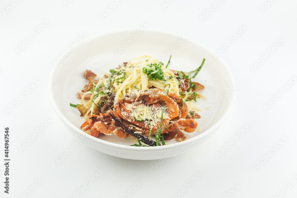 Spaghetti soft shell crab and cheese in white plate on white background Spaghetti soft shell crab and cheese in white plate on white background