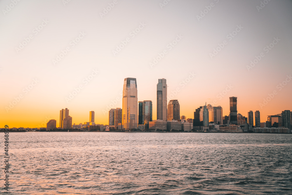 city skyline at sunset new jersey buildings skyscrapers sea ocean 
