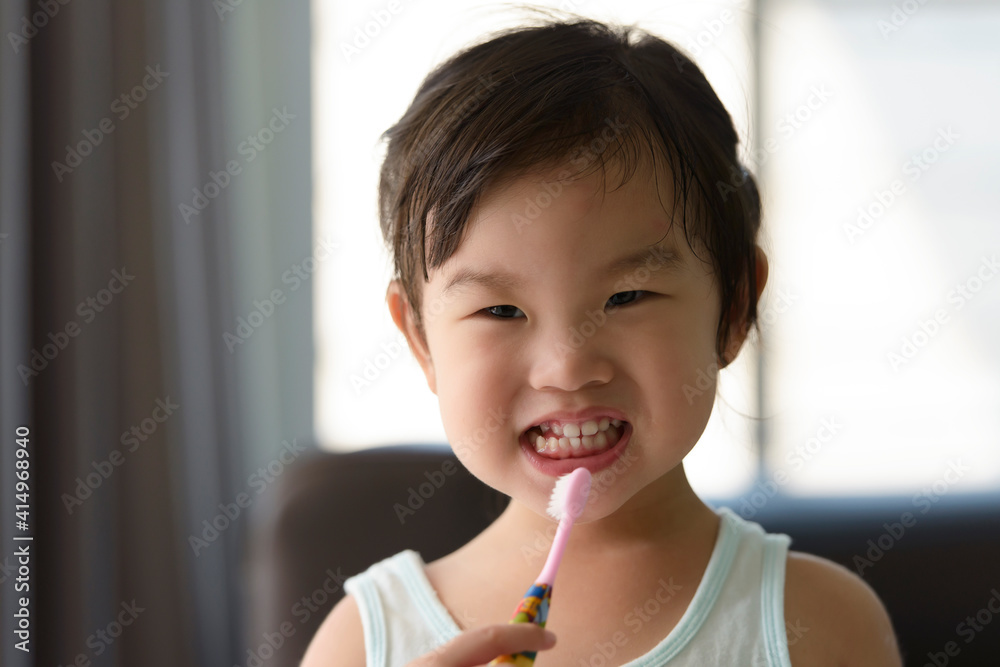 cute little Asian girl brushing her teeth. Healthy teeth concept. . cute little Asian girl brushing her teeth. Healthy teeth concept. .