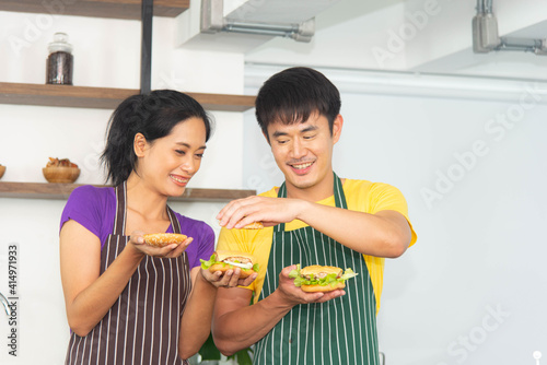 Asian romantic and lovely couple enjoy and happy cooking food in the kitchen