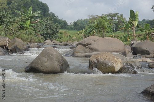 Big rock on the river with a natural background
