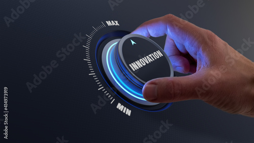 Enhancing innovation and technology development concept with a person choosing higher innovative products by turning a knob or dial by hand. Business strategy about engineering and research. photo