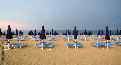 Bathhouse on an italian beach on the Adriatic Sea. The umbrellas draw beautiful geometries and have pleasant colors.