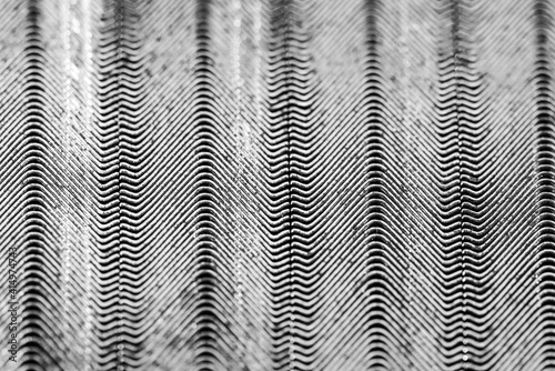 Monochrome image, V nails in rows close up macro, this special nails are used by picture framers to fix the frames.
