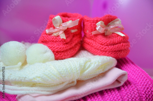 Baby girl knitted sandal, booties, shoes baby newborn, blank postcard. cocept it s a girl or baby shouer © Dilya