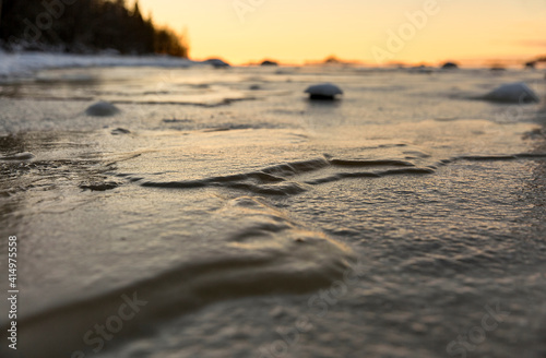 Close-up frozen lake ice surface at sundown