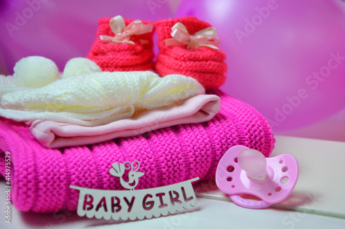 Baby girl knitted sandal, booties, shoes baby newborn, blank postcard. cocept it s a girl or baby shouer © Dilya