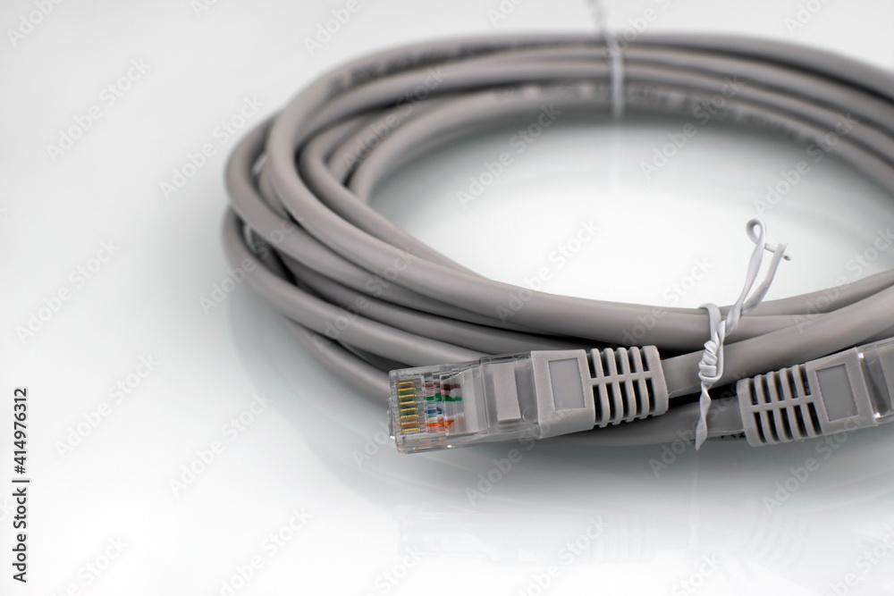 Internet cable on a white background. Connecting a computer to a network or LAN. Internet cable on a white background. Connecting a computer to a network or LAN.