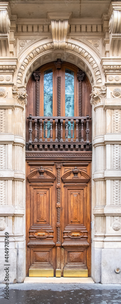 Paris, an ancient wooden door, typical building in the 11e arrondissement
