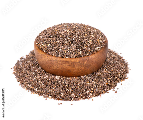 Chia seeds in wooden bowl, isolated on white background. Healthy superfood. Closeup macro of organic chia seeds.
