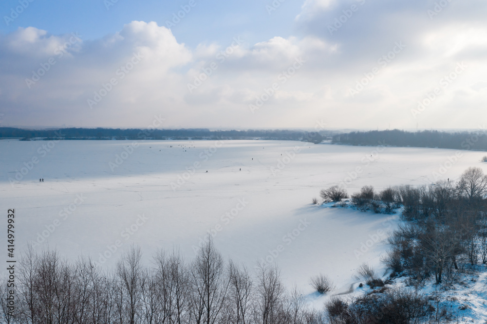 Gomel. Belarus. Soviet area. River Sozh. Winter fishing on the river. Fishermen are sitting on the ice. Swedish slide