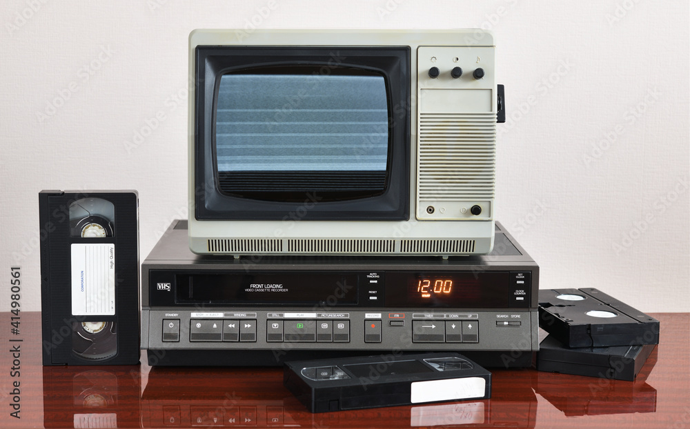 Old silver-colored TV with a VCR on the background of wallpaper.Screen noise.
Old silver-colored TV with a VCR on the background of wallpaper.Screen noise.