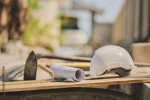 Fotografie White helmet hard hat  on wood floor in constriction site