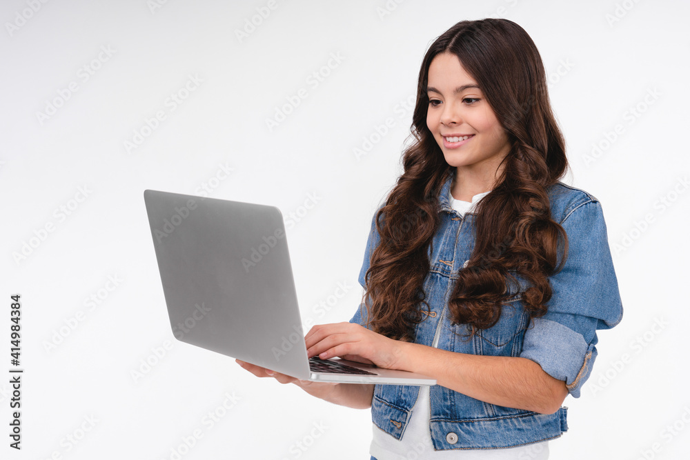 Happy caucasian girl using laptop in casual attire isolated in white background Happy caucasian girl using laptop in casual attire isolated in white background