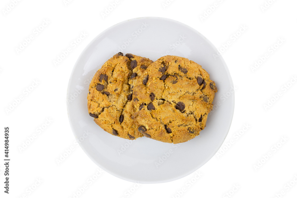 Two American cookies on a white porcelain saucer, top view. Isolated on white background. Two American cookies on a white porcelain saucer, top view. Isolated on white background.