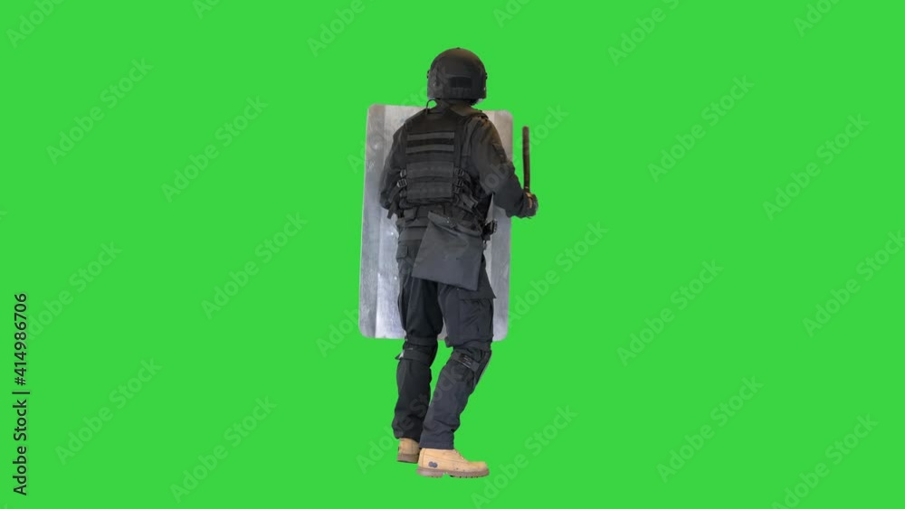 Riot police unit making sound hitting shield with baton on a Green Screen, Chroma Key. Riot police unit making sound hitting shield with baton on a Green Screen, Chroma Key.