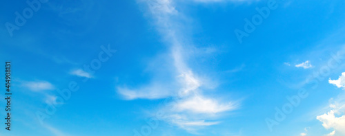 Bright blue sky with clouds. Wide photo.