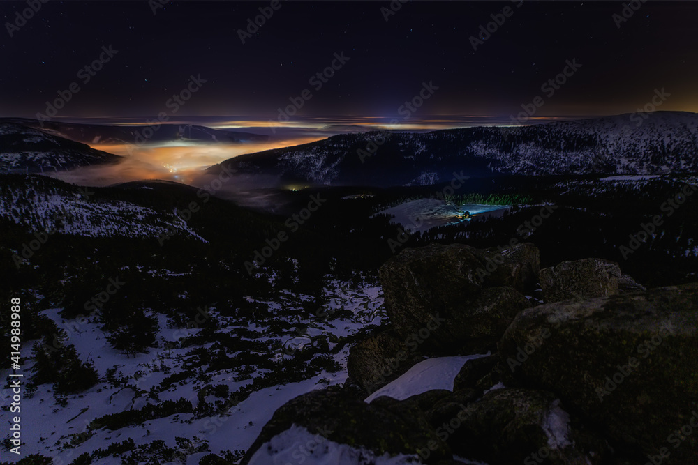 night snowy valley with fog and stars