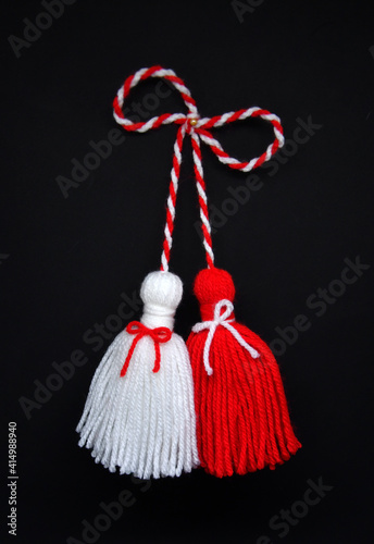 Traditional Bulgarian Martenitsa, red and white tassels. black background 