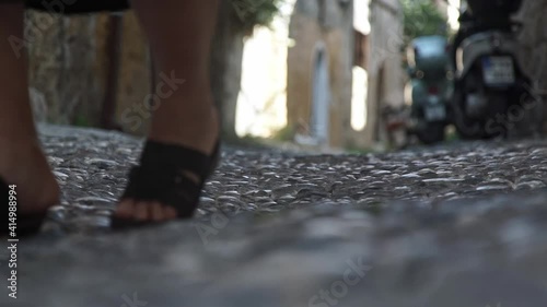 Old senior lady walking with stick. Close up feetof grandma.