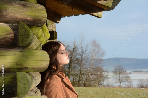 Women with a serious expression on her face and eyes closed in nature photo