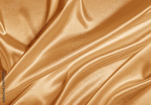 Gold silk fabric as an abstract background.