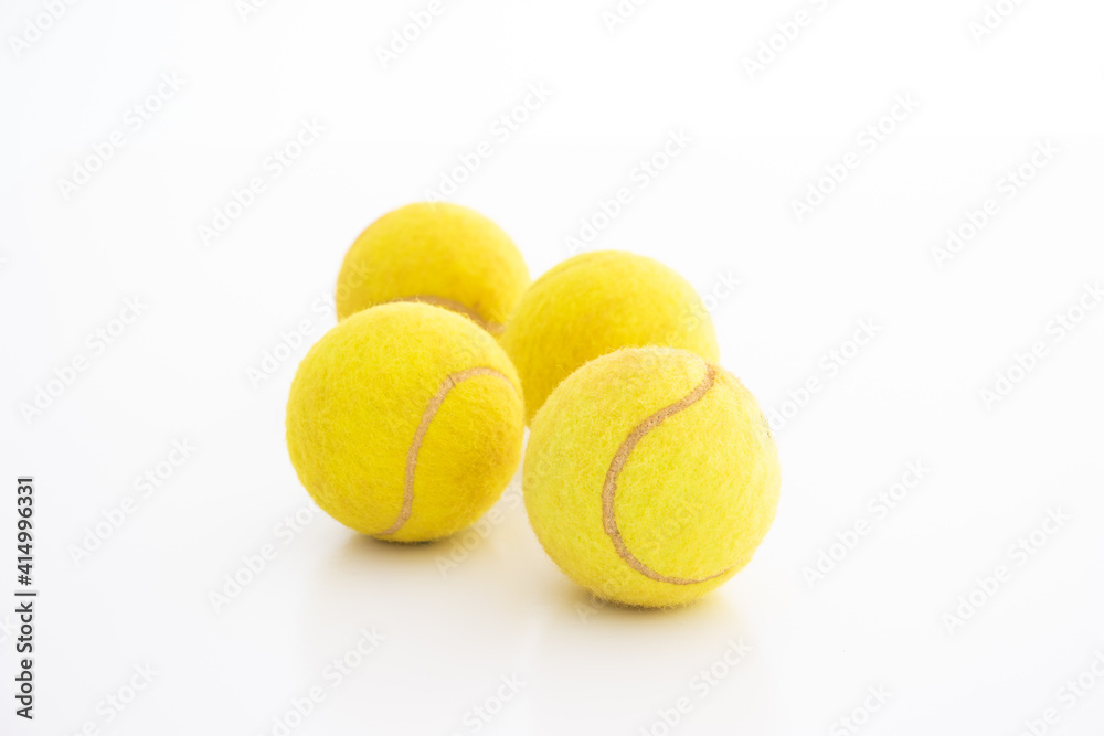 Four used generic tennis balls studio shot isolated on white background