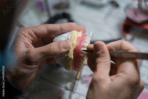 professional dentist builds custom-made dentures