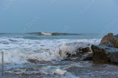Panoramic landscape view of sea waves from Arabian Sea crashing on the rocks of Gokarna Main Beach or Gokarna Middle Beach in Karnataka, India