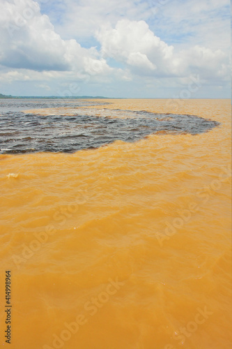  Meeting of the Waters of Rio Negro and the Amazon River or Rio Solimoes near Manaus, Amazonas, Brazil in South America. photo