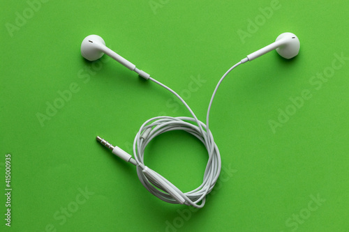White headphones, on a green background