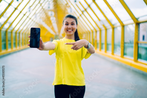 Smiling woman boasting with smartphone photo