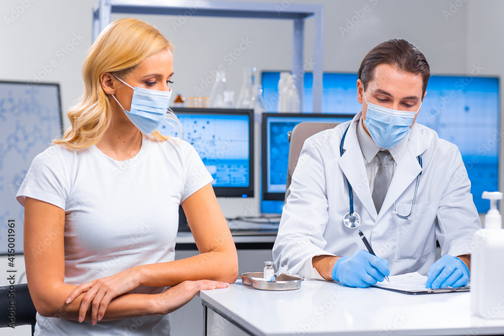 Obraz premium Professional doctor makes a coronavirus vaccine using a syringe and hypodermic needle. Professional medical worker and patient at the hospital office. Vaccination and safety.