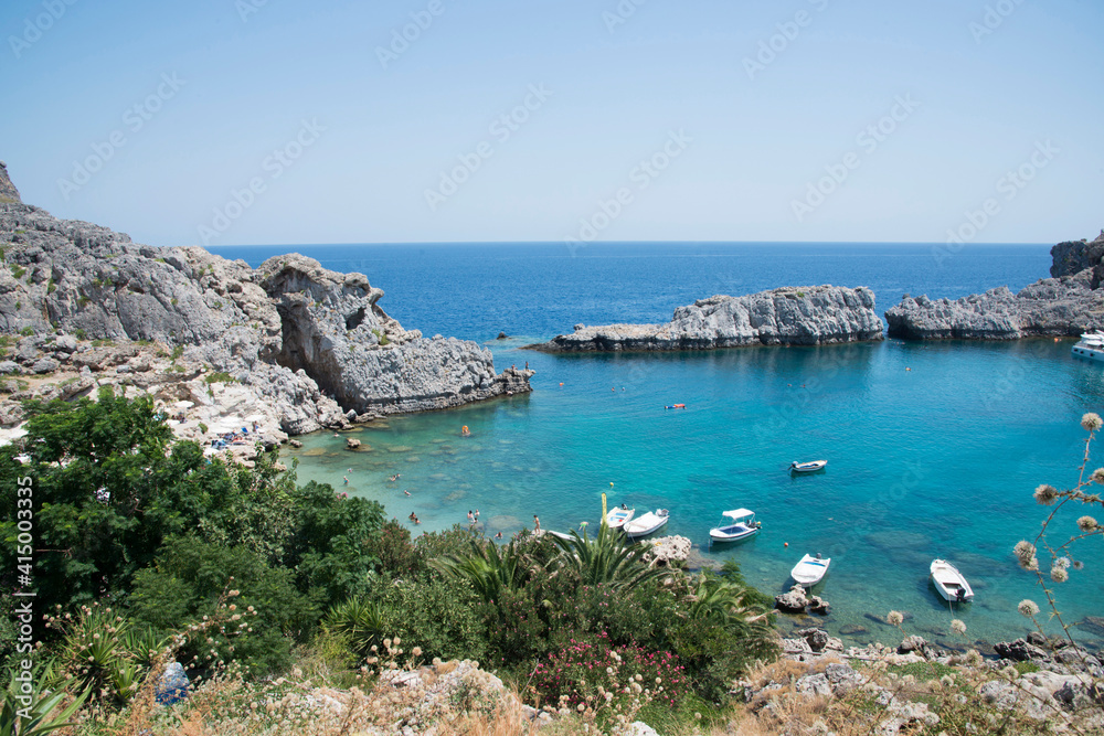 Fototapeta premium Beautiful landscape with a bay, boats and nature around close to Lindos, Rhodes, Greece